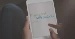 A person holding a tablet with an e-book opened to the title page reading "Practicing Affirmation" by Sam Crabtree.