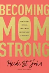 This is the book cover for *Becoming MomStrong* by Heidi St. John. The design features large gold text on a coral-colored background, with the title "Becoming Mom Strong" prominently displayed. The subtitle reads, "How to Fight With All That's in You for Your Family & Your Faith." Below that is the author's name, "Heidi St. John," written in a cursive script, along with "Author of The Busy Mom Blog."